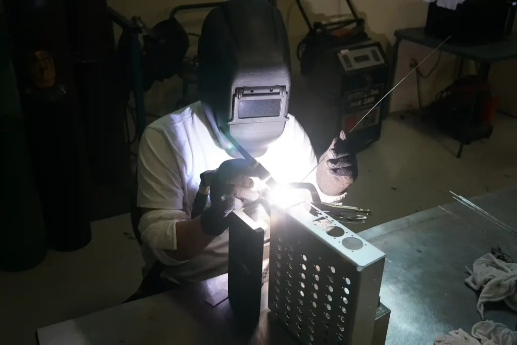 man welding metal fabricators