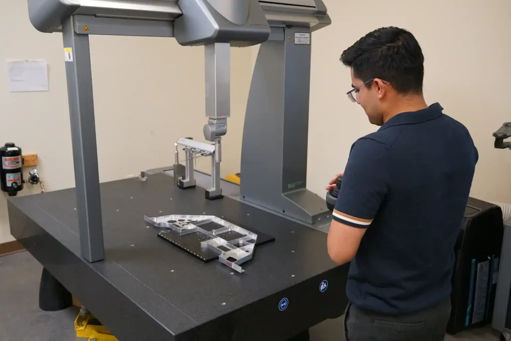 man doing quality assurance on precision parts fast manufacturing