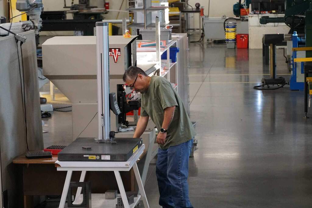 Man working machine at Savage with clean floor